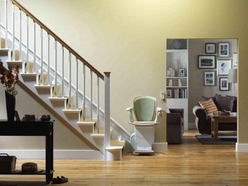 Curved Stannah stairlift installed on a home staircase for temporary use
